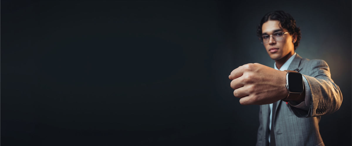 Man in a suit wearing a smartwatch on a leather strap